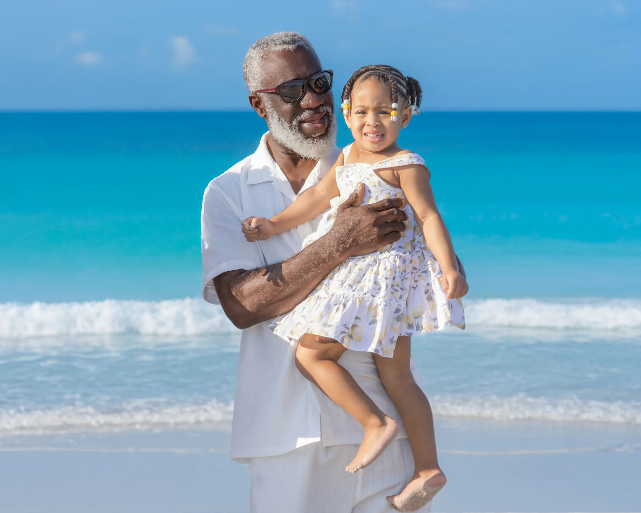 Grandfather and granddaughter enjoying a family moment by the ocean
